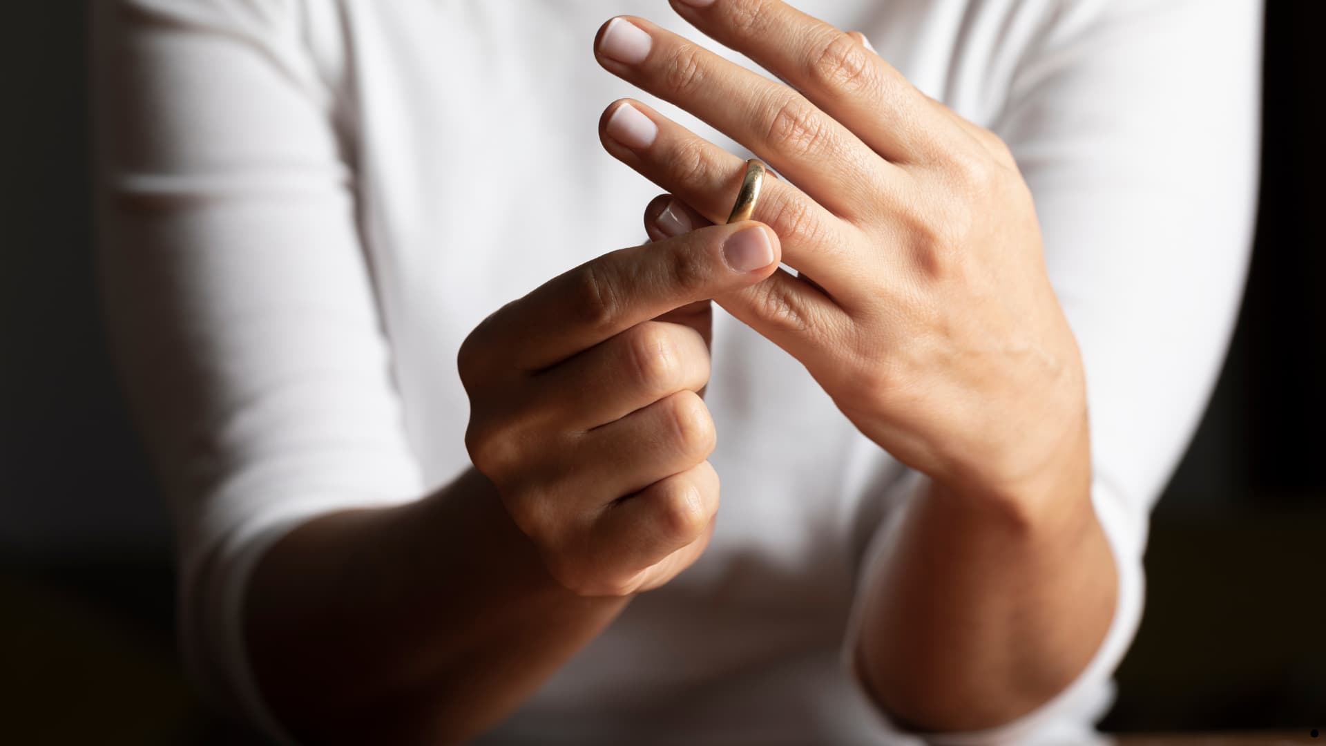 Woman taking off wedding ring